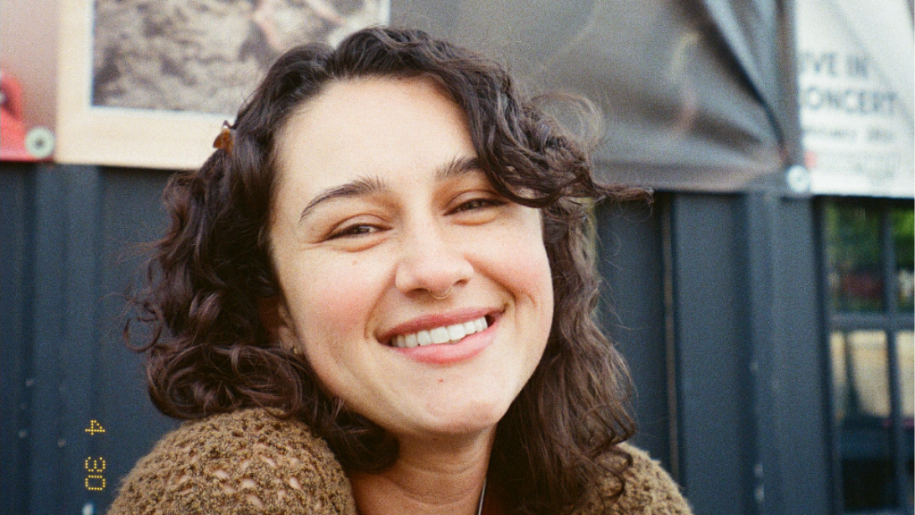 Picture of a woman smiling in front of a building